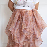 Plus-size model in The Twilight Bloom Bustle Skirt paired with a cute animal graphic tee, showing the high-low bustle detail.