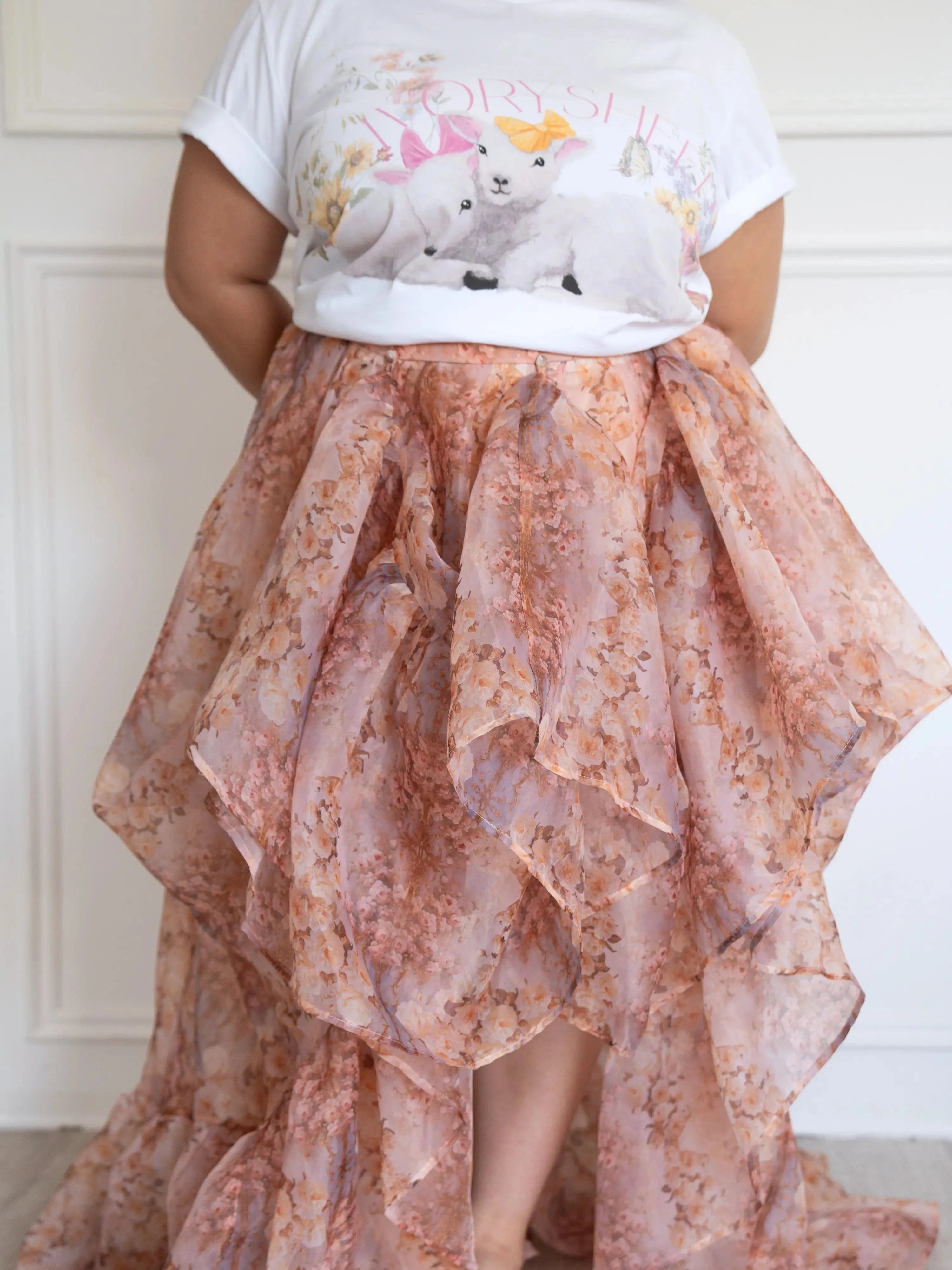 Plus-size model in The Twilight Bloom Bustle Skirt paired with a cute animal graphic tee, showing the high-low bustle detail.