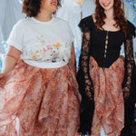 Two women wearing The Twilight Bloom Bustle Skirt in a floral organza fabric, styled with a graphic tee and a black lace corset top.