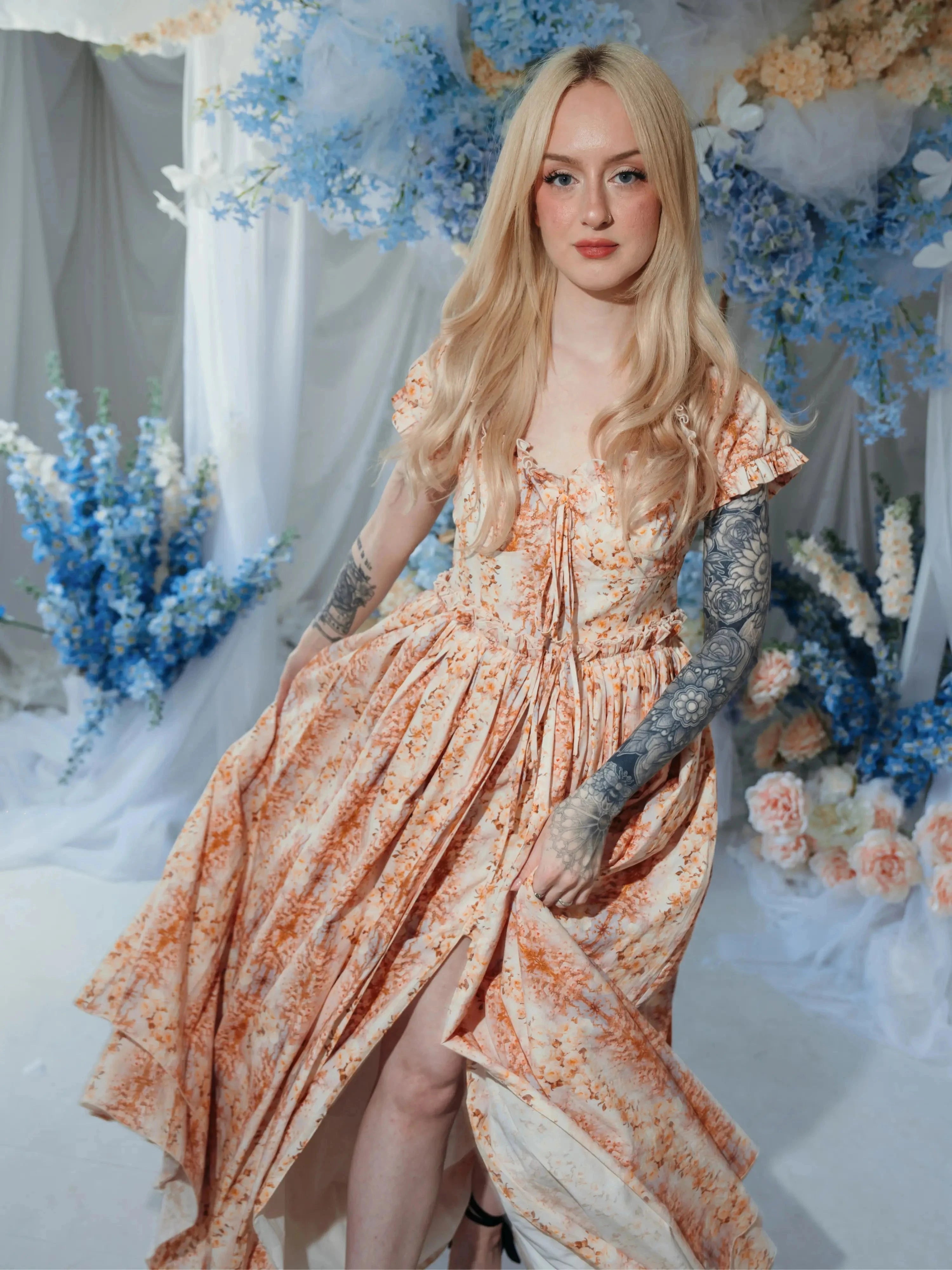 Romantic Twilight Bloom Meadow Gown styled in a floral studio, featuring layered skirt and sweetheart neckline.