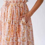 Close-up of Twilight Bloom Meadow Gown showing floral cotton fabric and hidden side pocket detail.