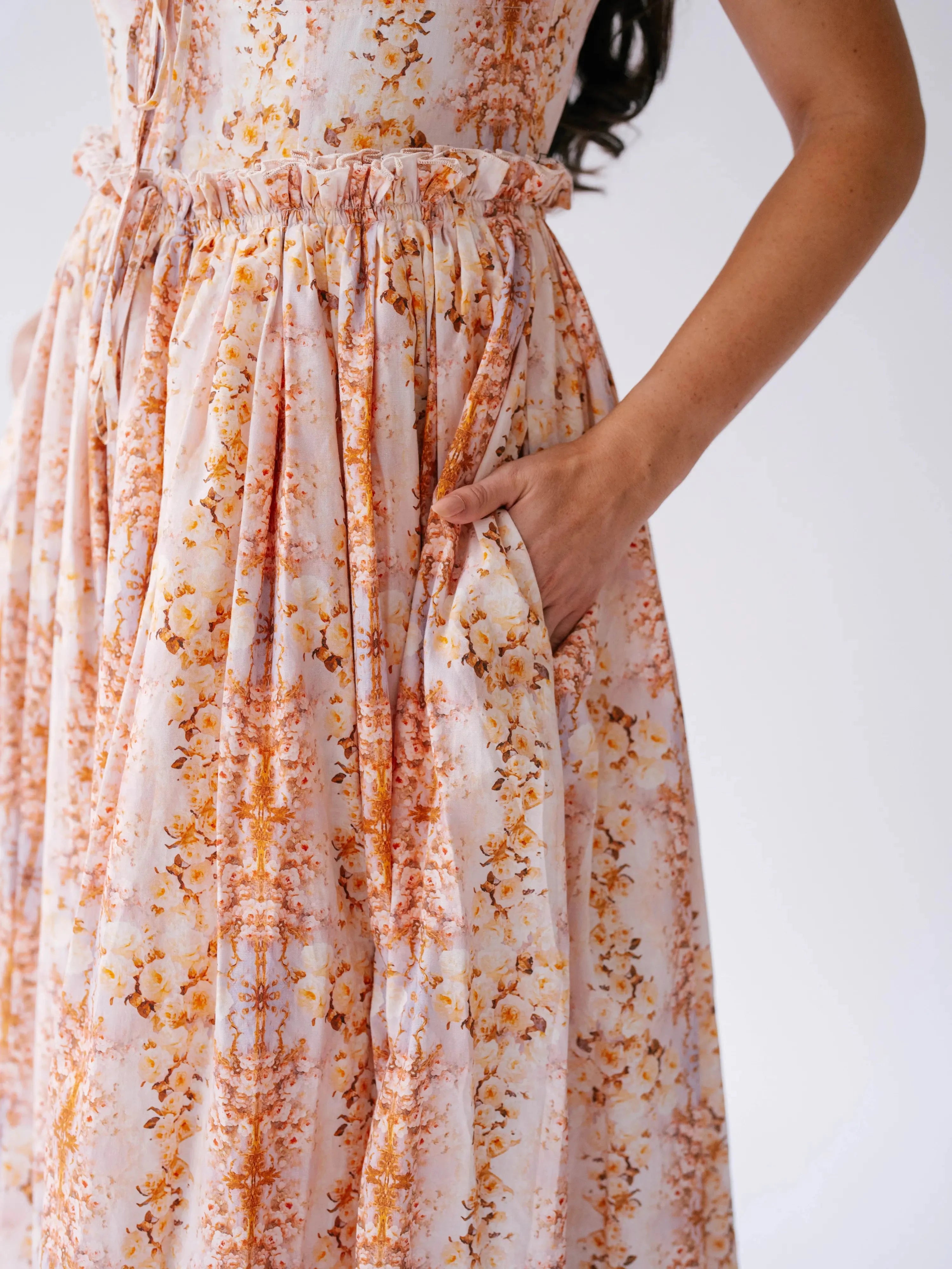 Close-up of Twilight Bloom Meadow Gown showing floral cotton fabric and hidden side pocket detail.