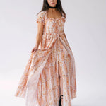 Twilight Bloom Meadow Gown with front slit and ruched bodice, displayed in a standing pose to show flowy silhouette.