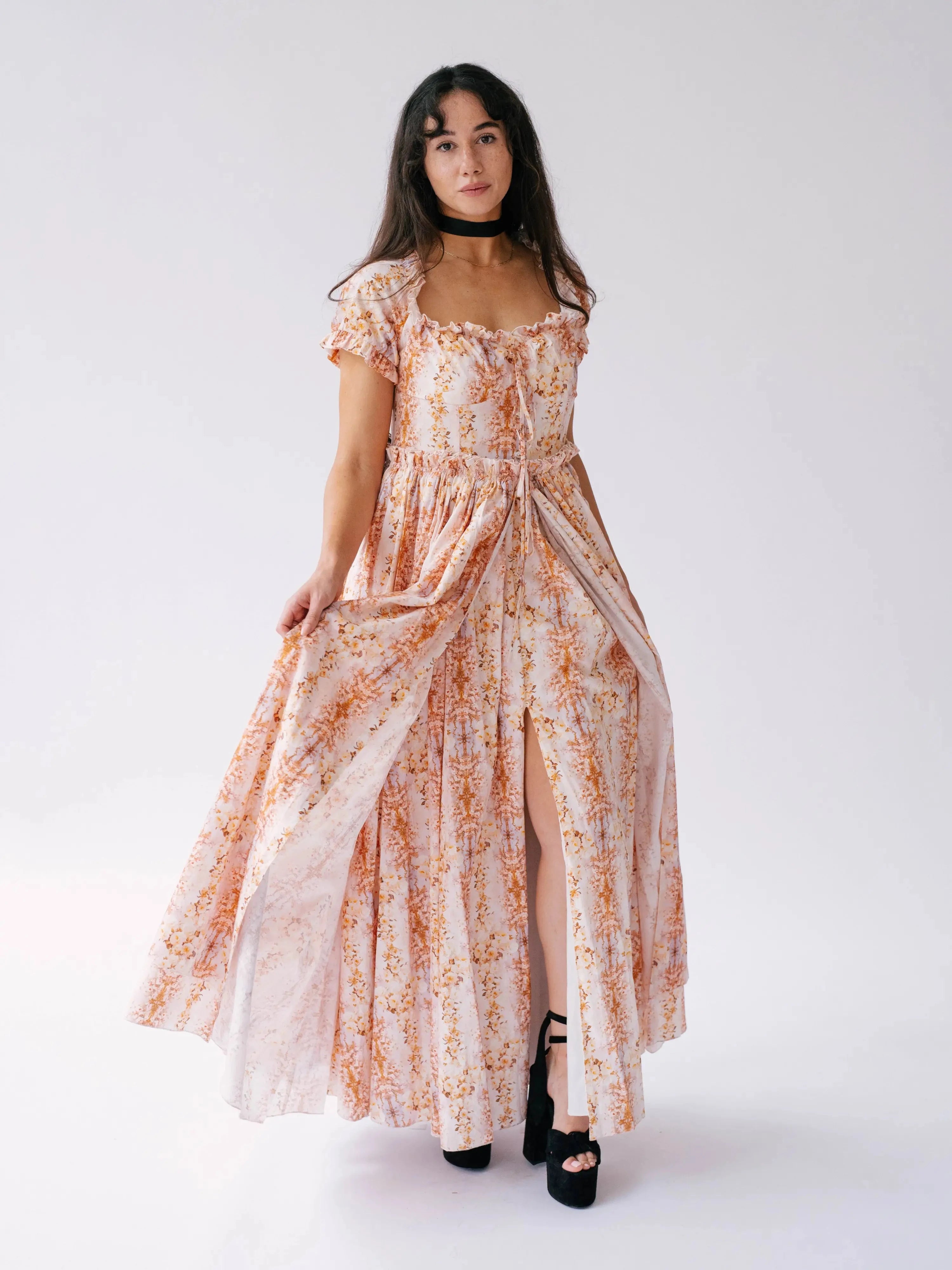 Twilight Bloom Meadow Gown with front slit and ruched bodice, displayed in a standing pose to show flowy silhouette.