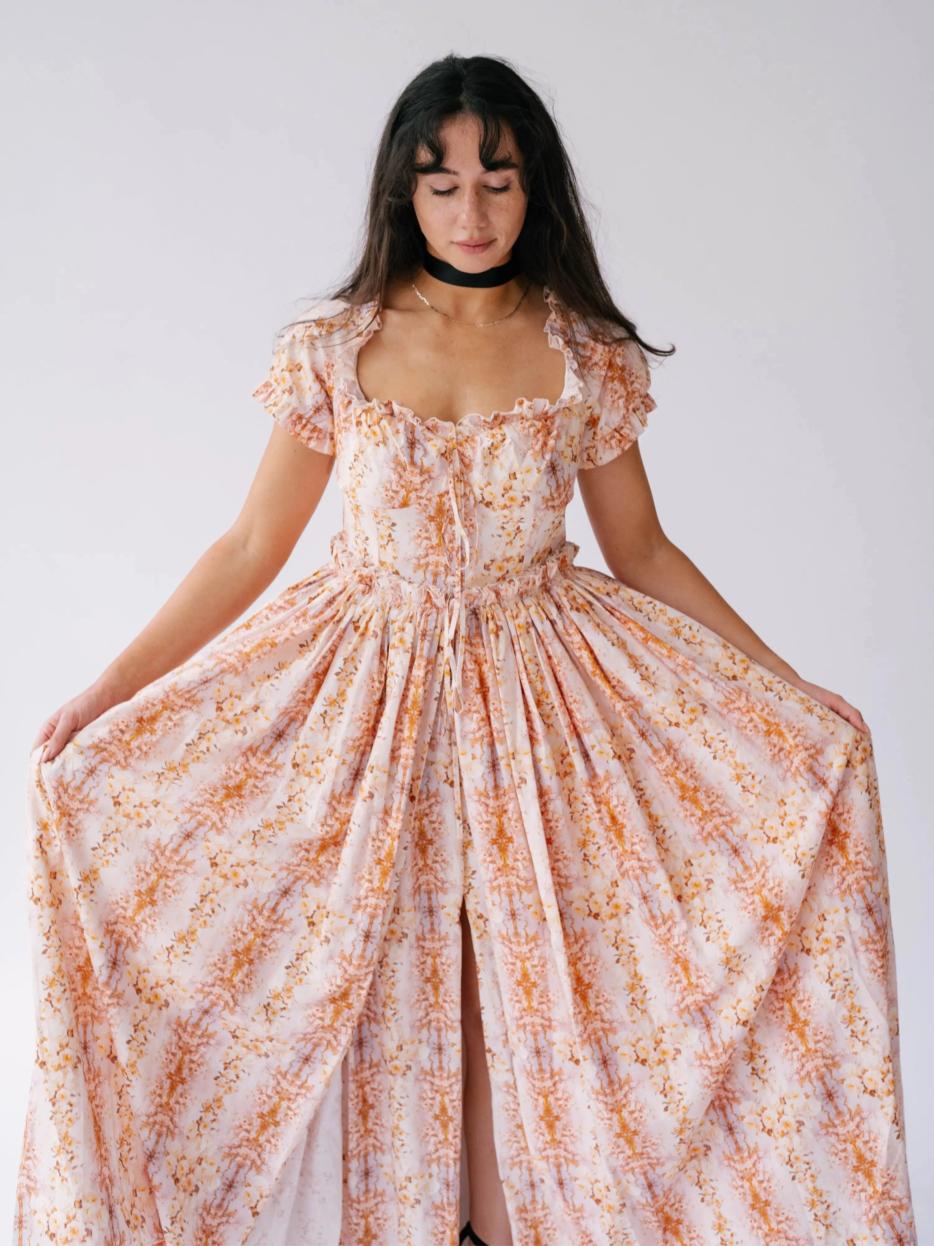 Twilight Bloom Meadow Gown with puff sleeves and floral print, shown front-facing with full skirt spread out.