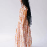 Side profile of Twilight Bloom Meadow Gown maxi dress with puff sleeves and flowing floral skirt.