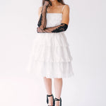 White tiered sundress with spaghetti straps paired with black platform sandals and long black lace opera gloves.