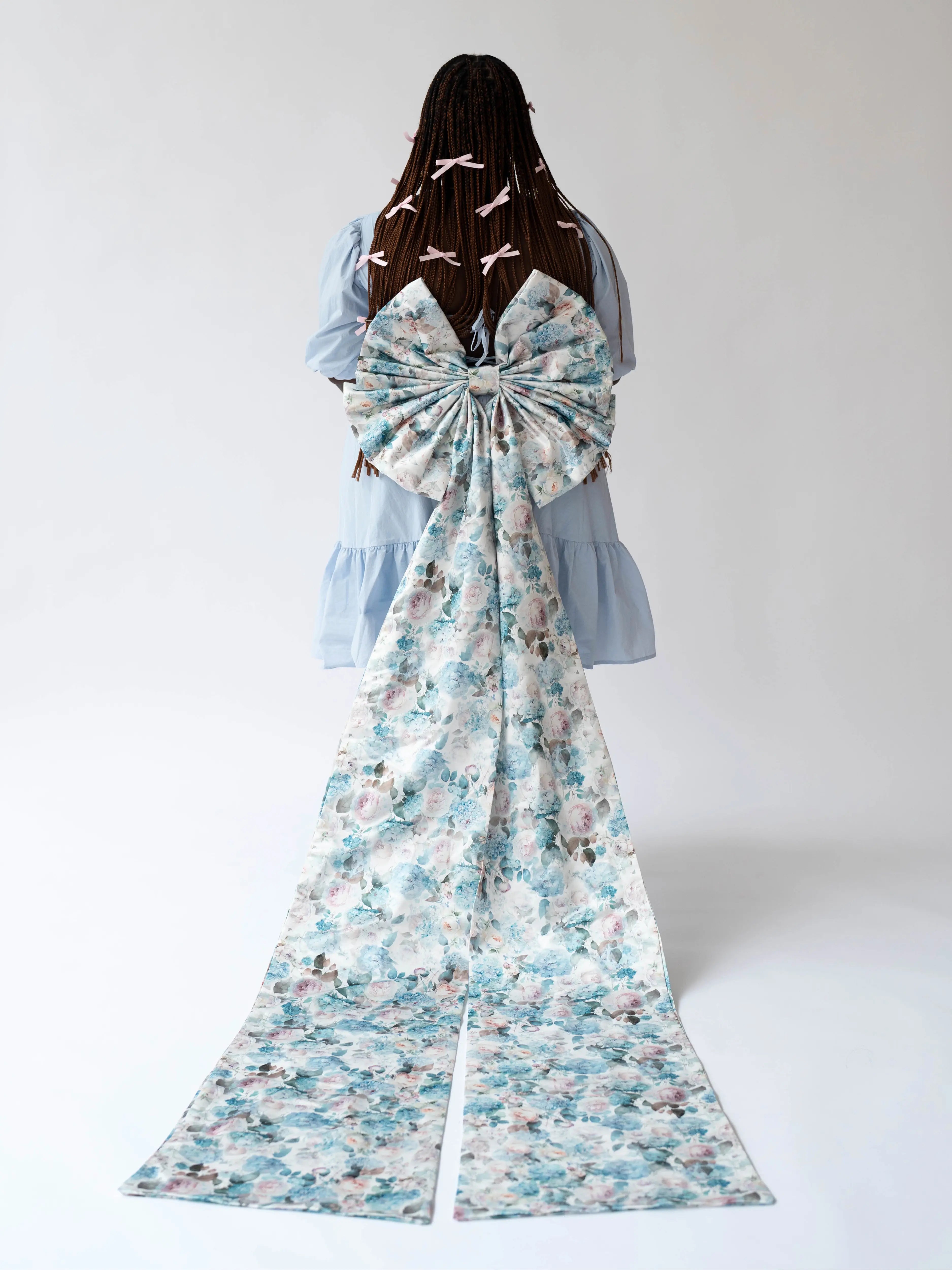 The Alice Blue Josephine Midi Dress with a dramatic large floral print bow sash belt cascading down the back.