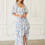 Floral print maxi dress with puff sleeves and a ruffled bustle skirt.