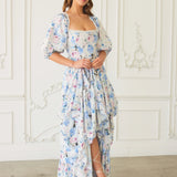 Floral print maxi dress with puff sleeves and a ruffled bustle skirt.