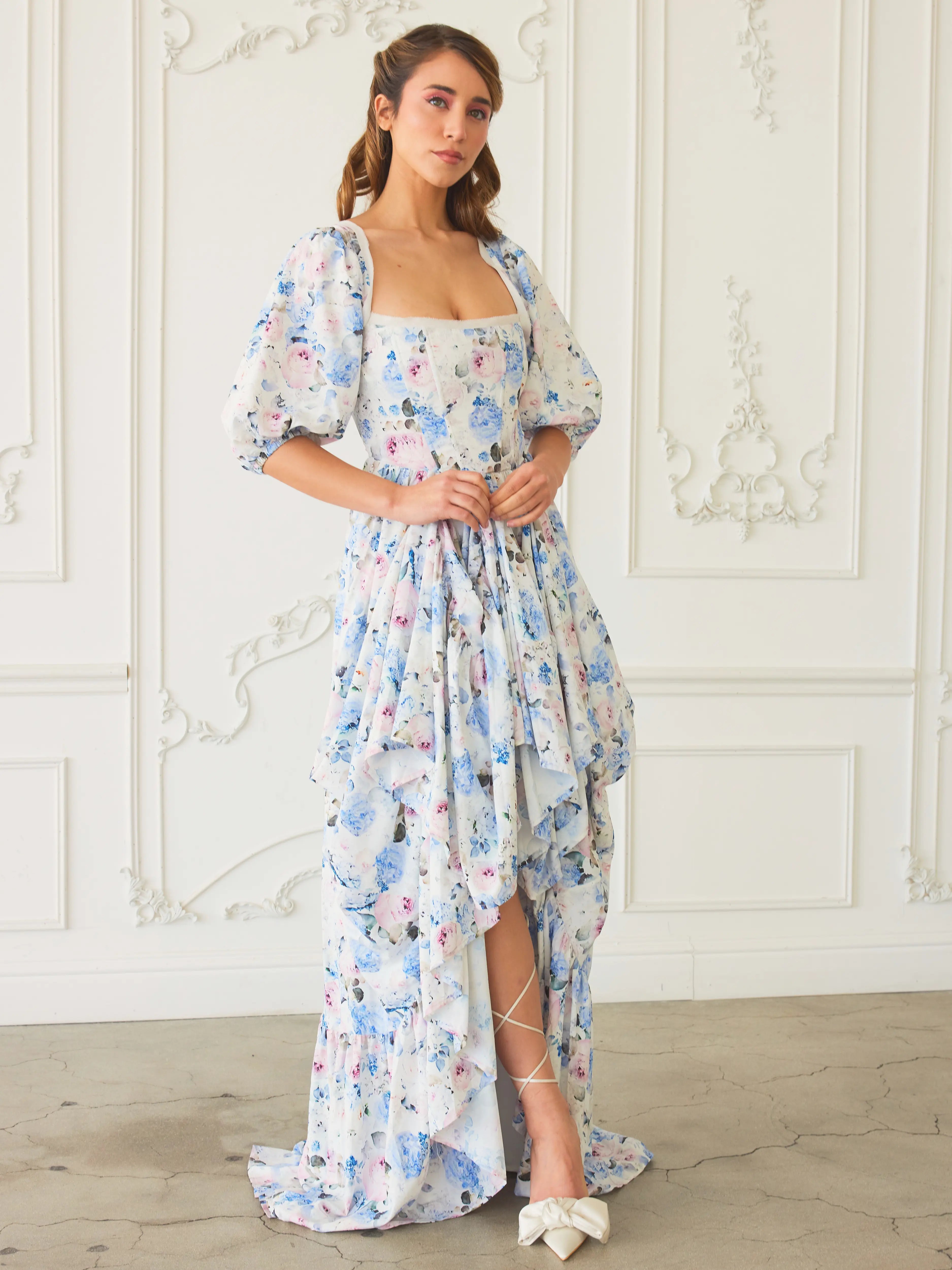 Floral print maxi dress with puff sleeves and a ruffled bustle skirt.