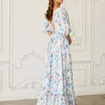 Corset maxi dress with ruffled tiers and puff sleeves in a white and blue floral print called Wildbloom.