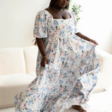 A floral print maxi dress with puff sleeves and a square neckline.