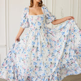 A floral print ball gown with puff sleeves and a square neckline in white, blue and pink tones.