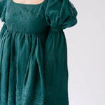 Forest green holiday mini dress with puff sleeves and embroidered details.