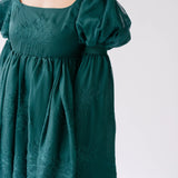 Forest green holiday mini dress with puff sleeves and embroidered details.