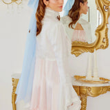 Woman in elegant white and pink gown with Alice Blue Giant Flutter Bow veil