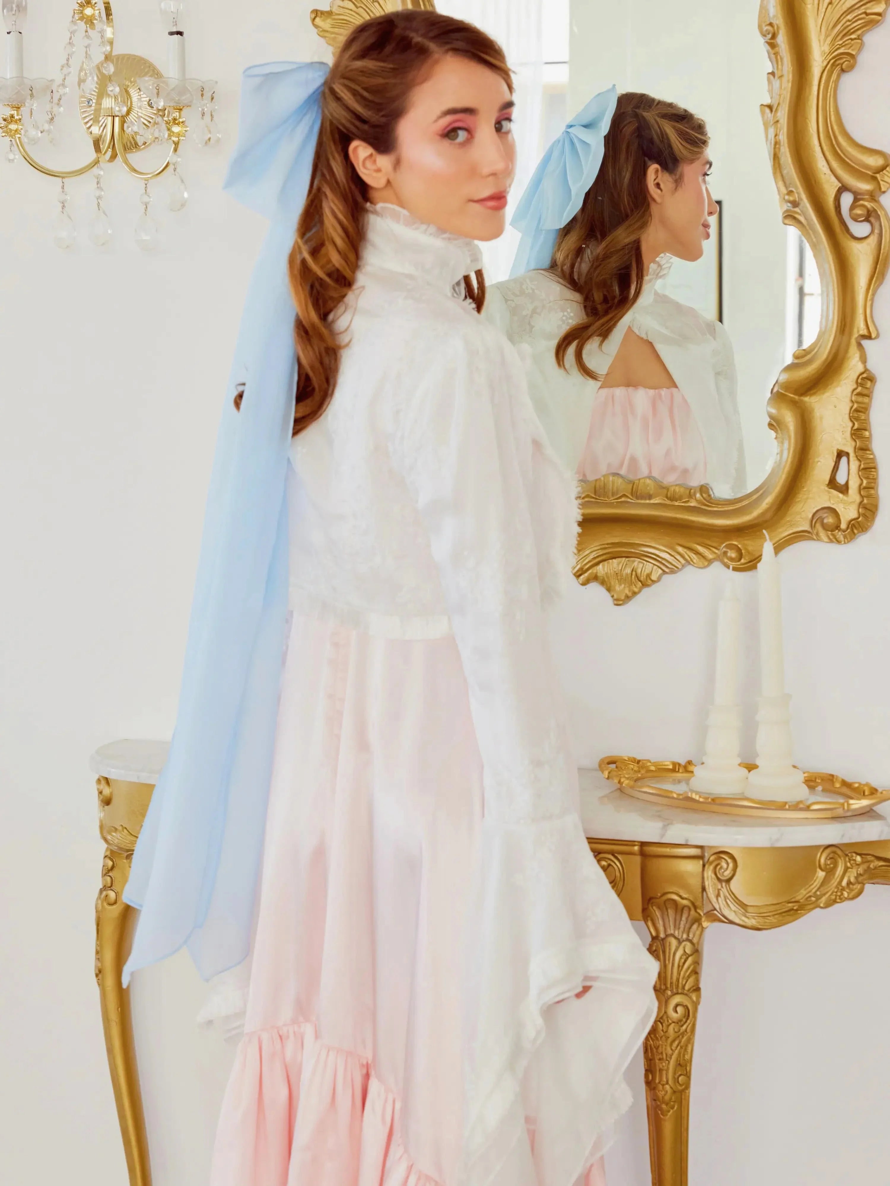 Woman in elegant white and pink gown with Alice Blue Giant Flutter Bow veil