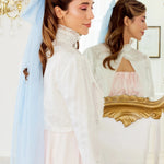 Caylee wearing the Alice Blue Grand Hair Bow featuring dreamy 36-inch tails, styled with a high-neck embroidered blouse for an ethereal aesthetic.