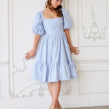 Light blue Josephine Midi Dress featuring puff sleeves and a tiered skirt