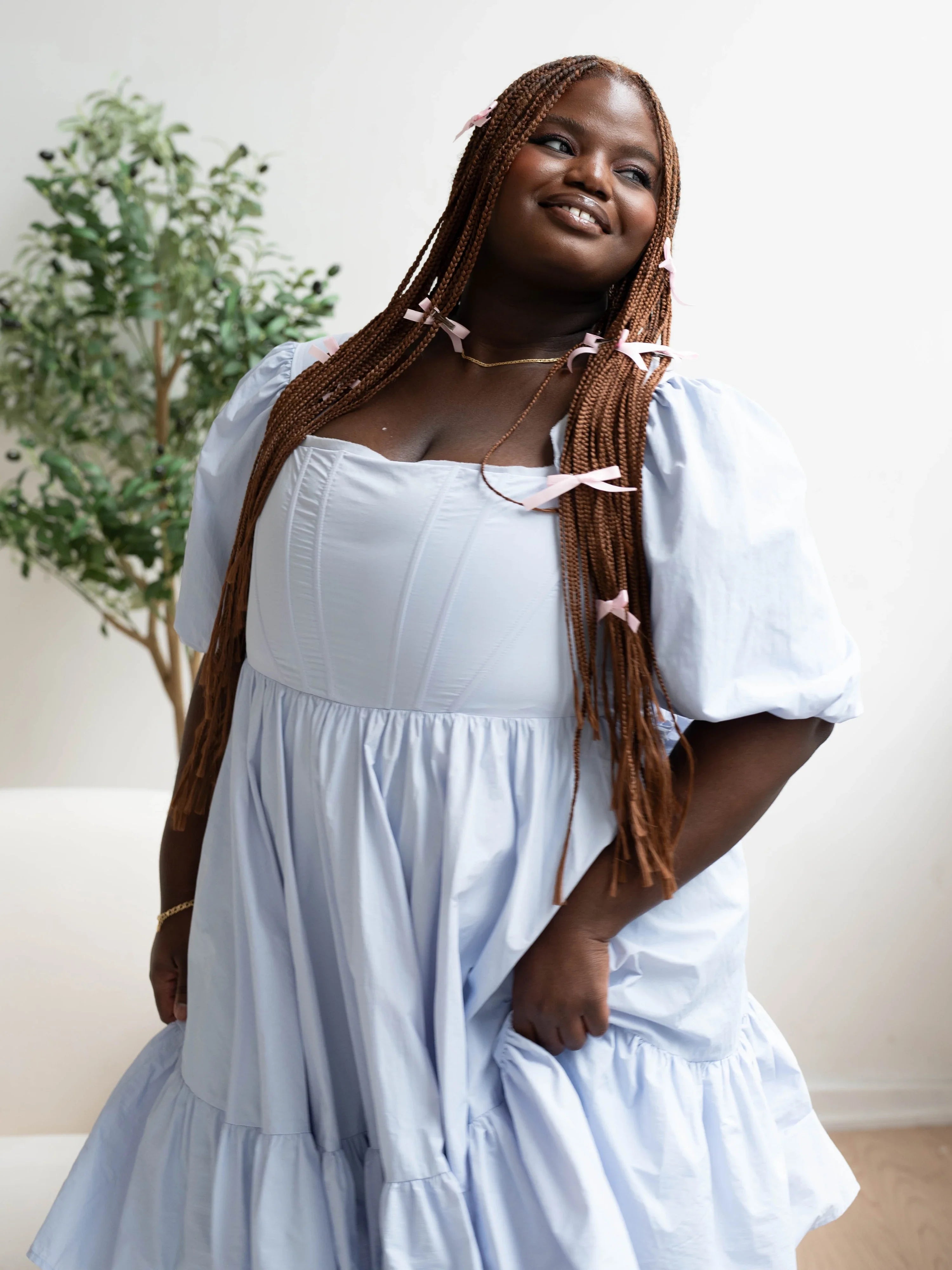 Smiling woman in Alice Blue Josephine Midi dress with flowing tiered skirt