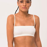 Woman in Atwood Camisole Top with braided hair and glasses, styled elegantly