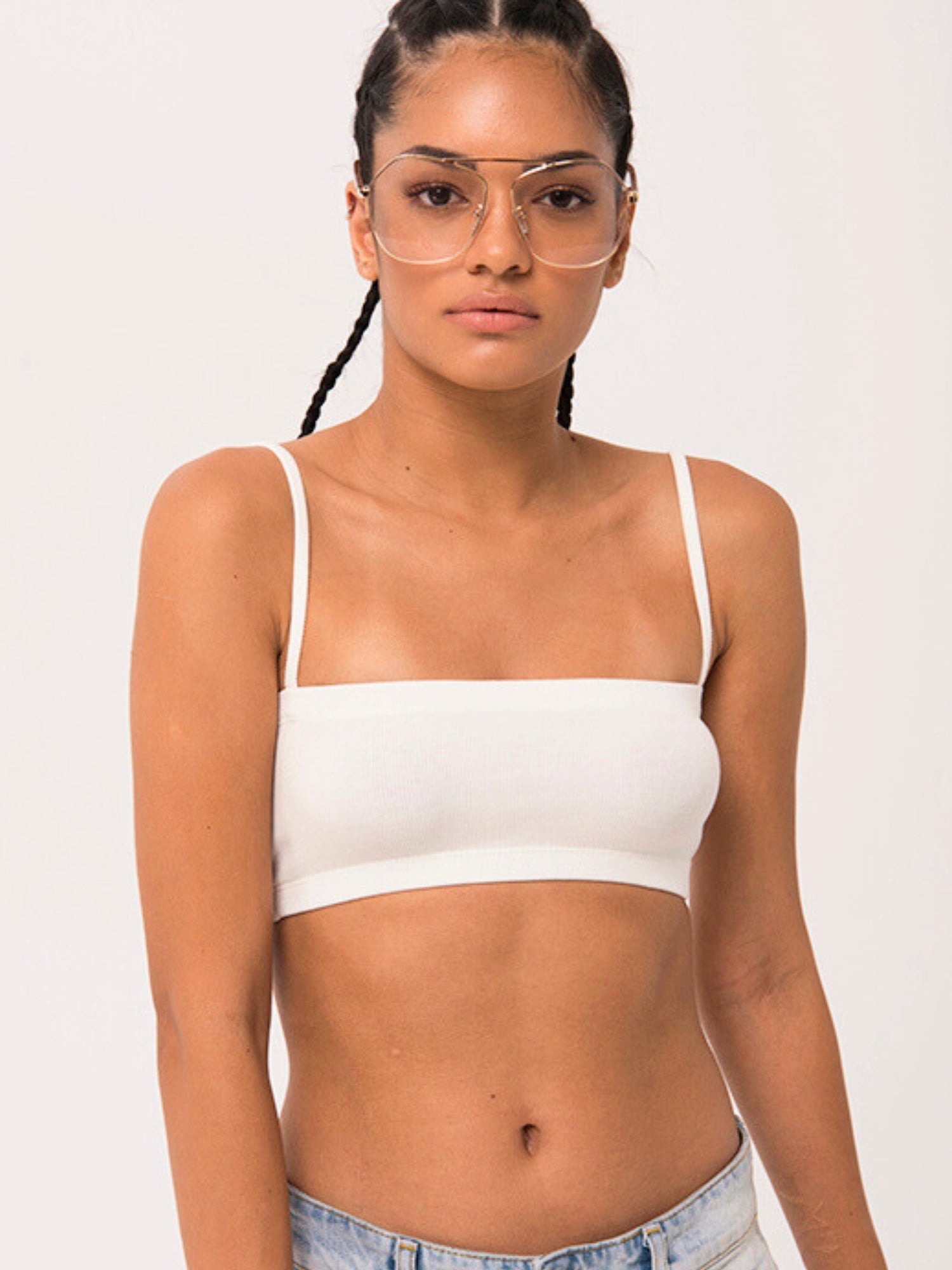 Woman in Atwood Camisole Top with braided hair and glasses, styled elegantly