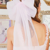 White bow in a bridal hairstyle featuring the Ballerina Giant Flutter Bow