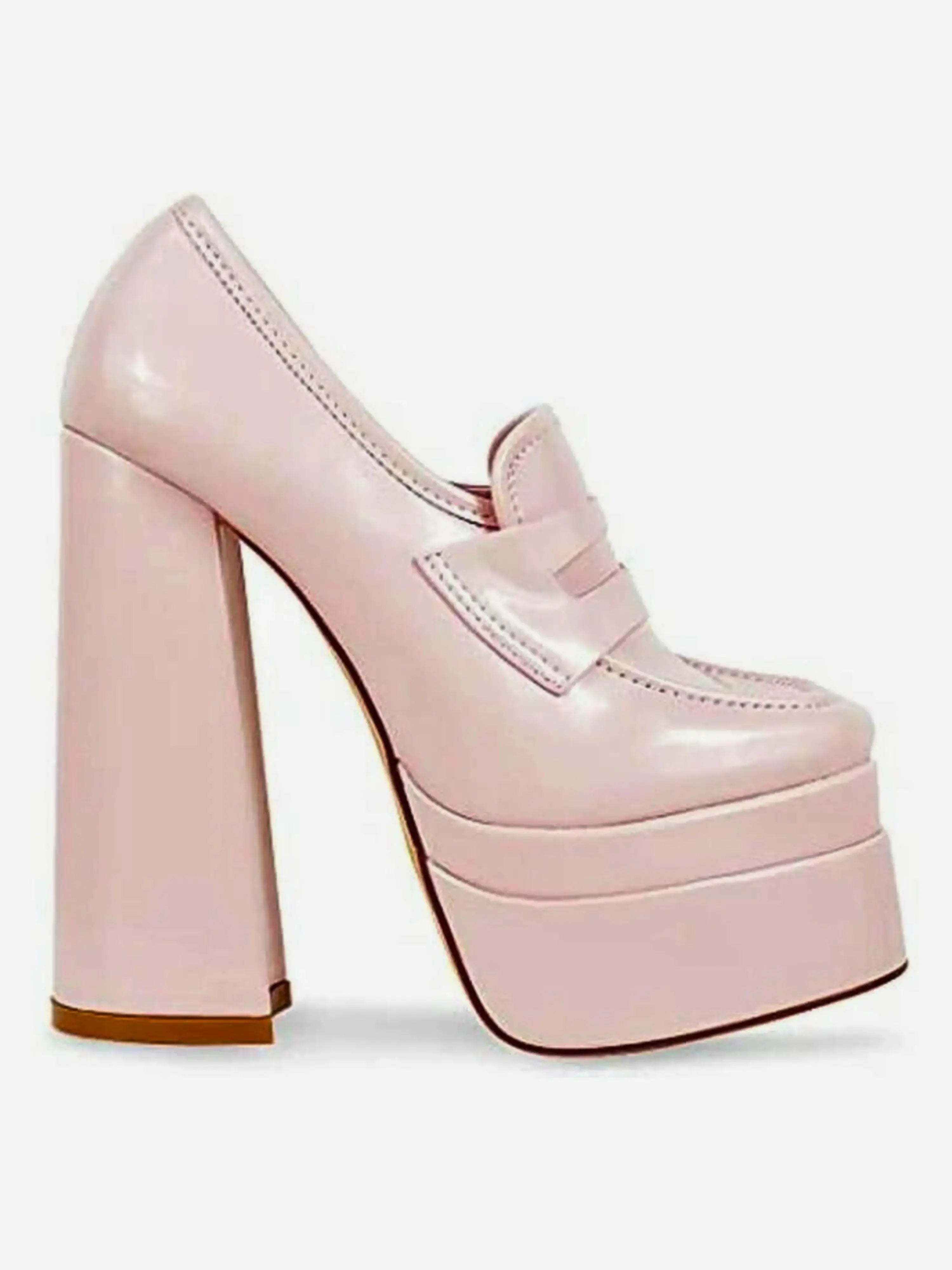 Side profile of Barbie’s Pink Penny Loafers showing the glossy pink finish, tall block heel, and classic penny loafer upper in a platform style.