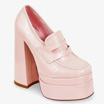 Angled view of Barbie’s Pink Penny Loafers featuring a shiny pink upper, high platform sole, and structured loafer design for standout style.