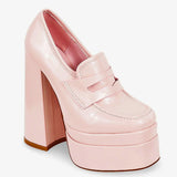 Angled view of Barbie’s Pink Penny Loafers featuring a shiny pink upper, high platform sole, and structured loafer design for standout style.