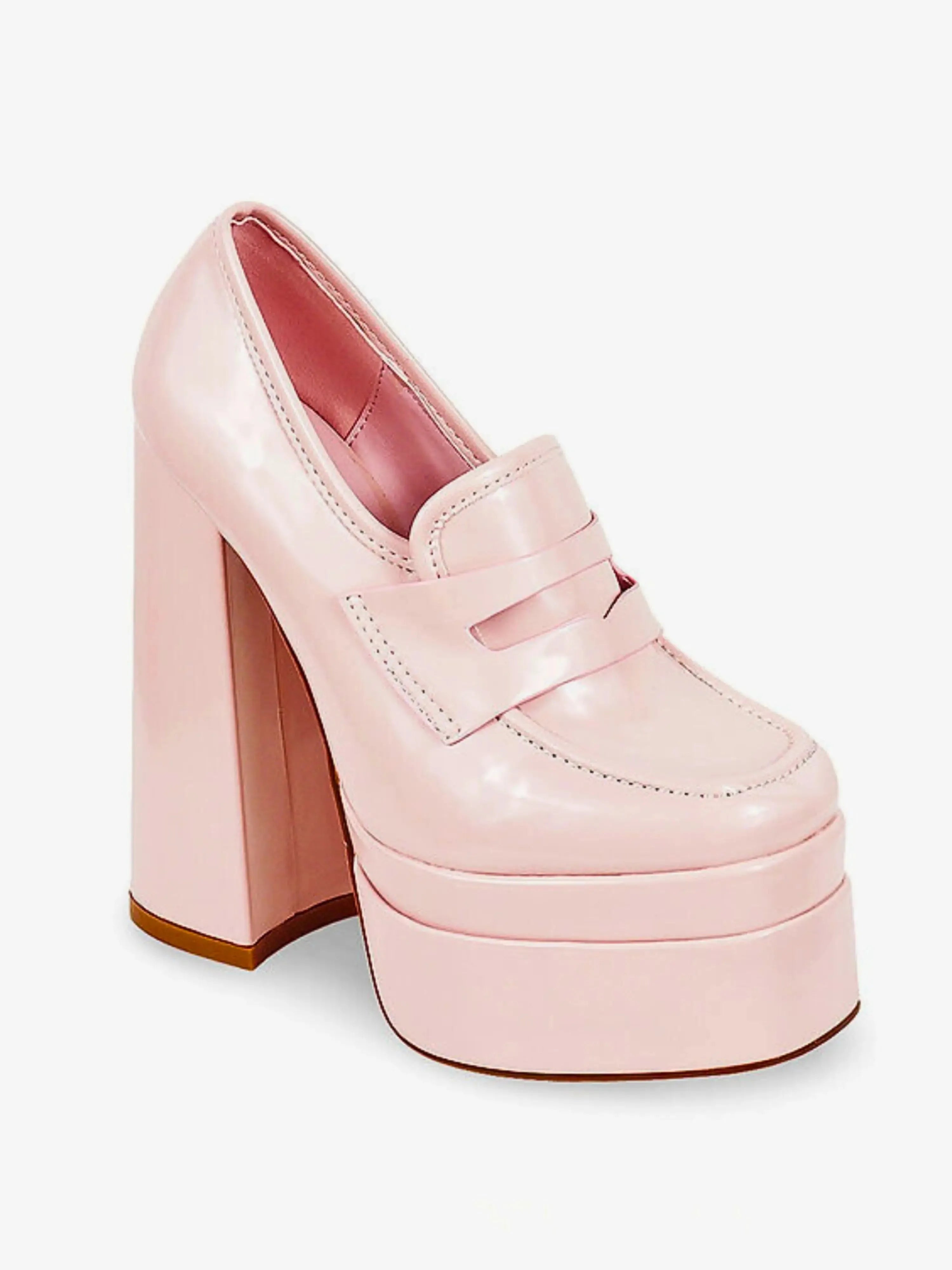 Angled view of Barbie’s Pink Penny Loafers featuring a shiny pink upper, high platform sole, and structured loafer design for standout style.