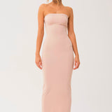 Woman wearing the Barely There Strapless Long Cami Slip Dress in pale pink