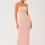 Woman wearing a strapless long cami slip dress in pale pink for a chic look