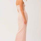 Sleeveless pale pink strapless long cami slip dress worn by a woman