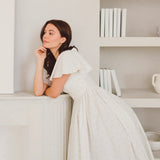 Woman in a white dress leaning on a shelf in Blue Blooms French Milkmaid Dress