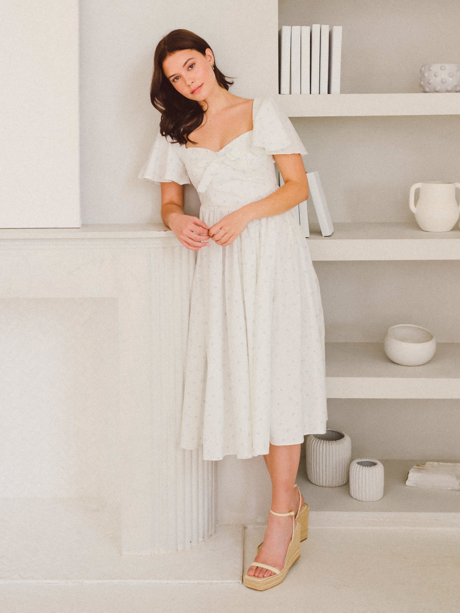 Woman in white off-shoulder midi dress from Blue Blooms French Milkmaid collection