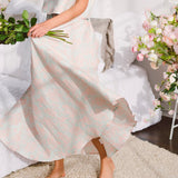 Long white Candy Floss St. Tropez Maxi Skirt with flowing skirt held by a person