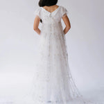 Back view of the Celestial Veil Dauphine Lace Gown showcasing V-back and celestial lace train.