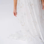 Detail of the Celestial Veil Dauphine Lace Gown's embroidered stars and moons on sheer tulle. Perfect for fantasy-inspired or bridal fashion.