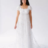 Celestial Veil Dauphine Lace Gown featuring empire waist and celestial embroidery, modeled in full view.