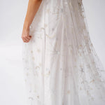 Close-up of the Celestial Veil Dauphine Lace Gown's moon and star embroidery on it's train.