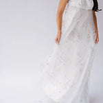 Flowing lace gown with short sleeves and a delicate, ethereal quality.