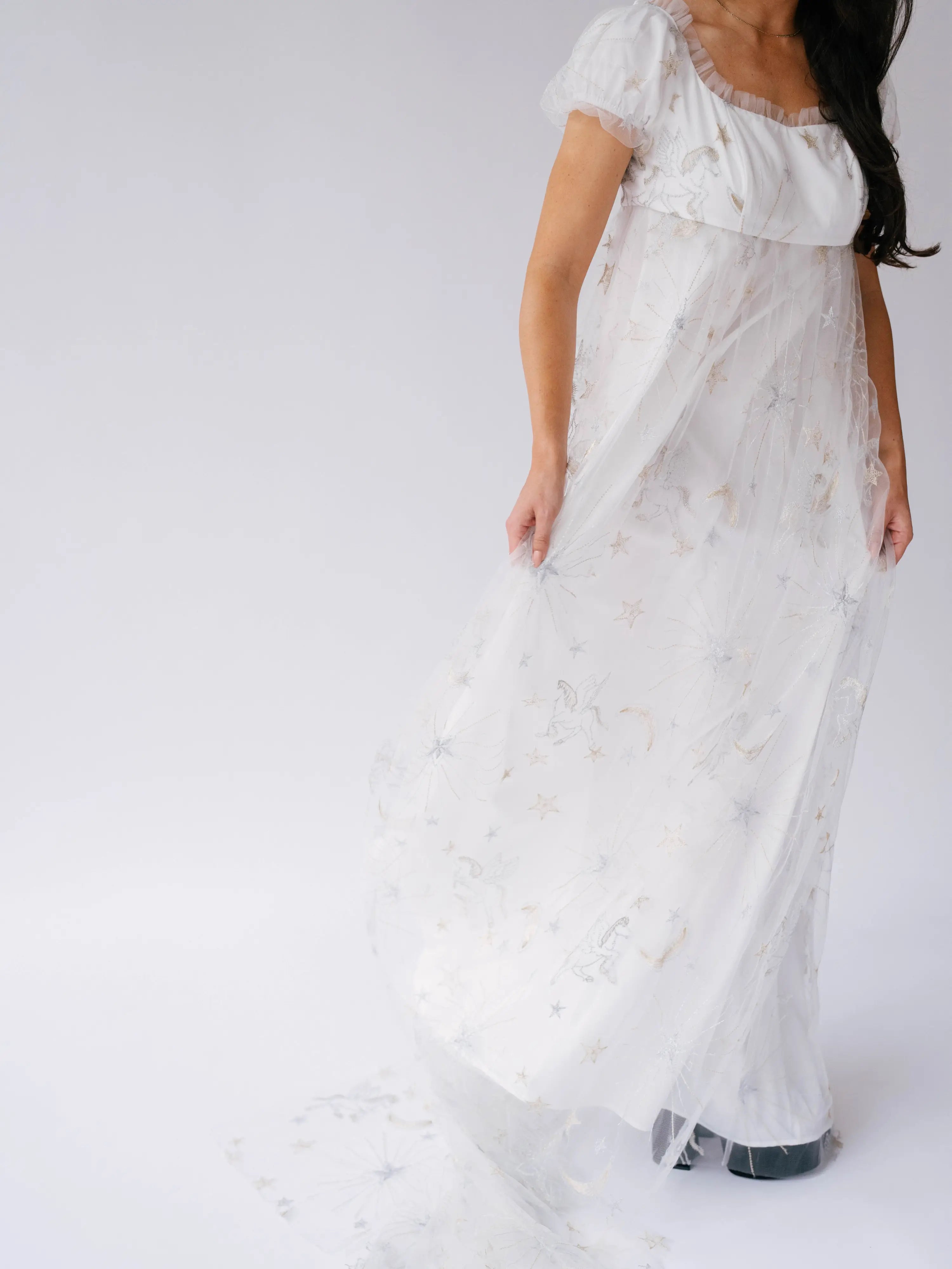 Flowing lace gown with short sleeves and a delicate, ethereal quality.