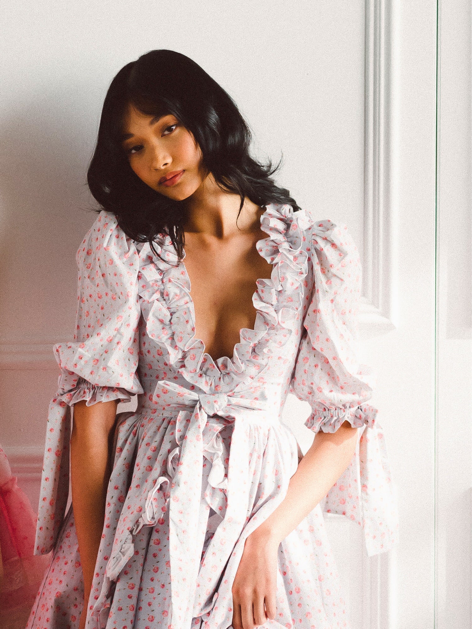 Woman in a pale pink floral robe with ruffles from the Chateau Rose Marie Dress