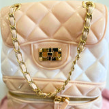 Quilted pale pink Jelly Backpack Purse with gold chain straps and decorative clasp