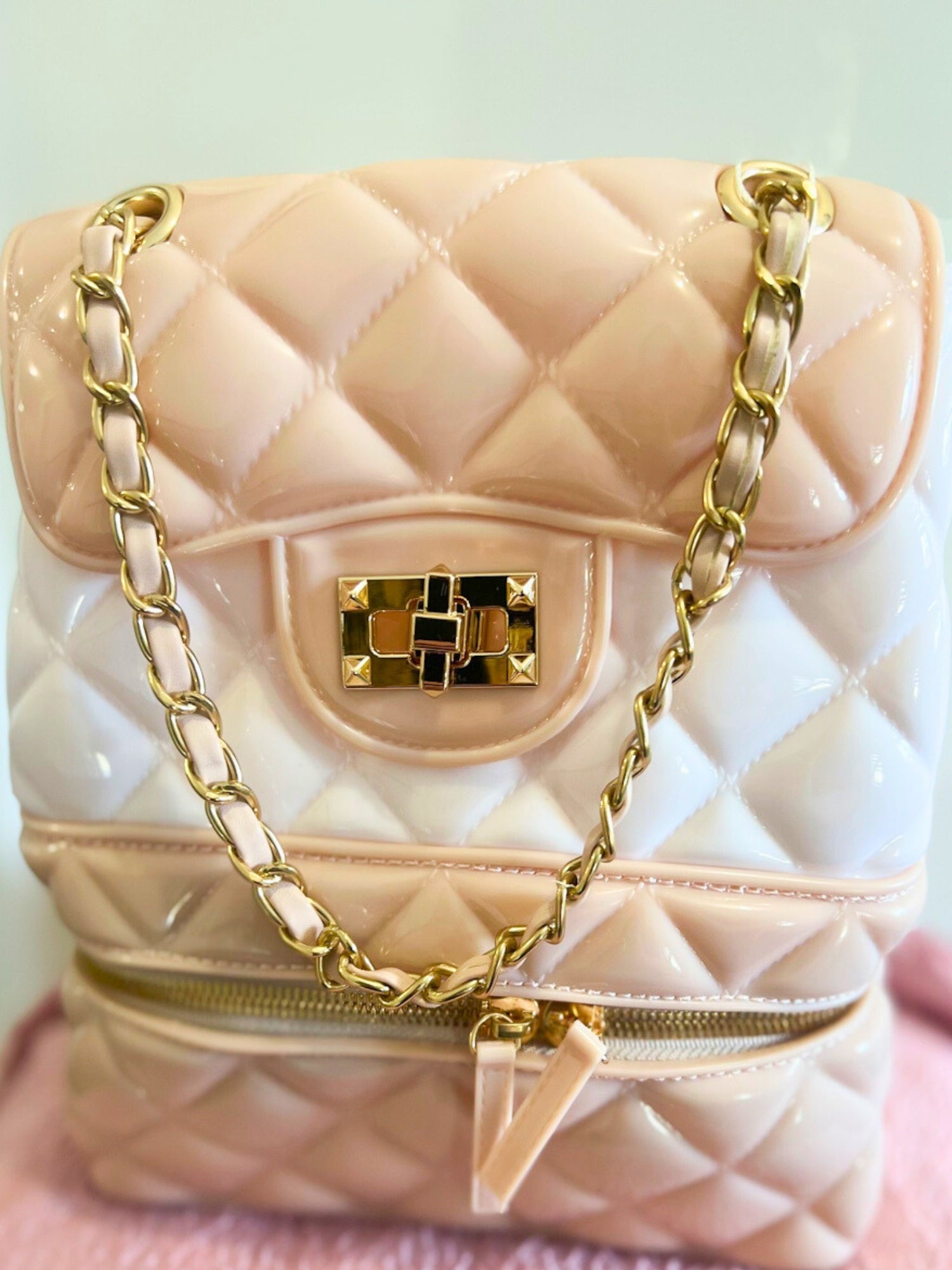 Quilted pale pink Jelly Backpack Purse with gold chain straps and decorative clasp