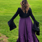 Woman in a purple skirt and black flared sleeve top wearing a Cotton Everyday Dress