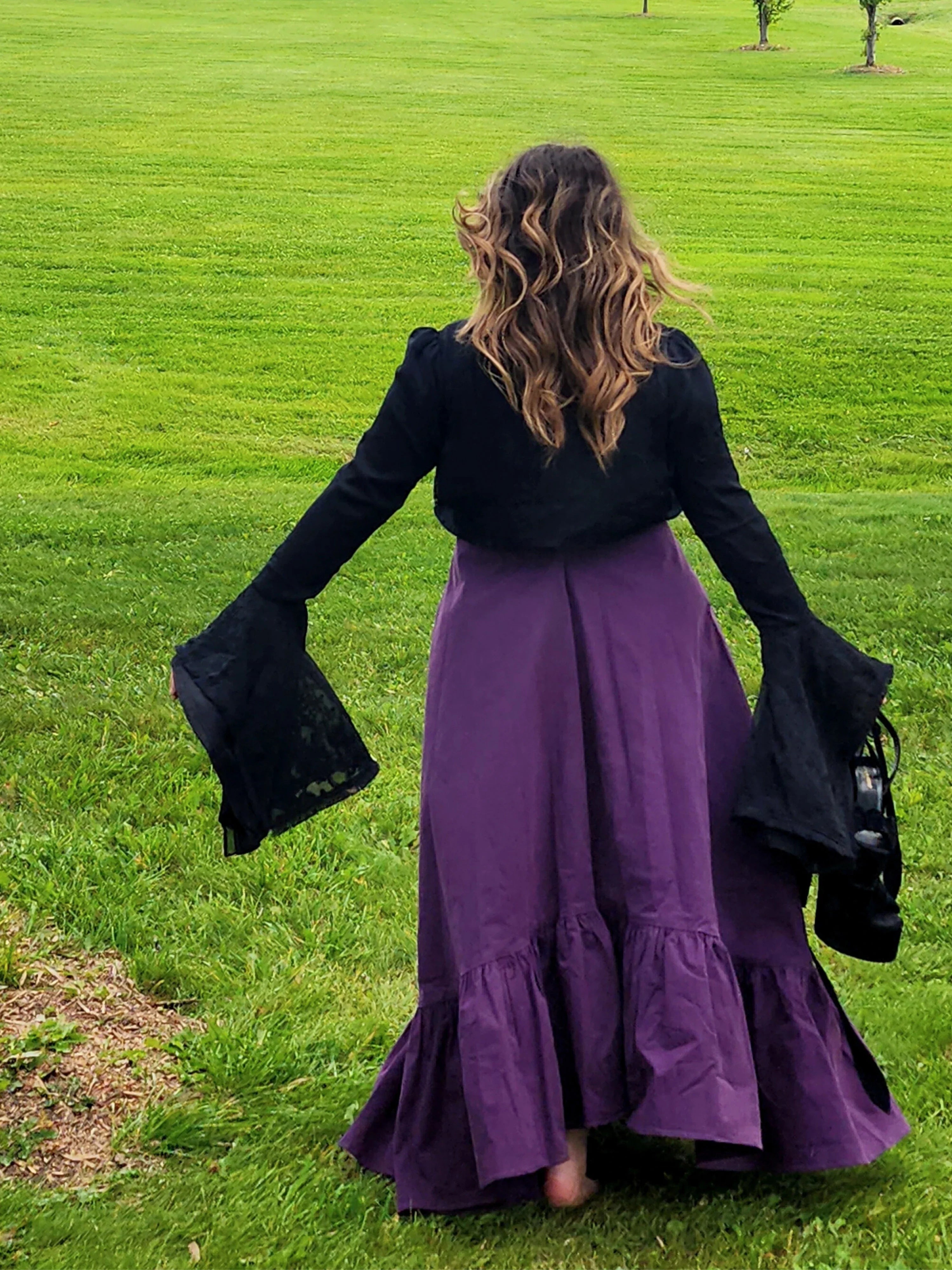 Woman in a purple skirt and black flared sleeve top wearing a Cotton Everyday Dress