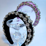 Ornate Diamond Goddess Headbands in black and pink with crystals on a glass stand